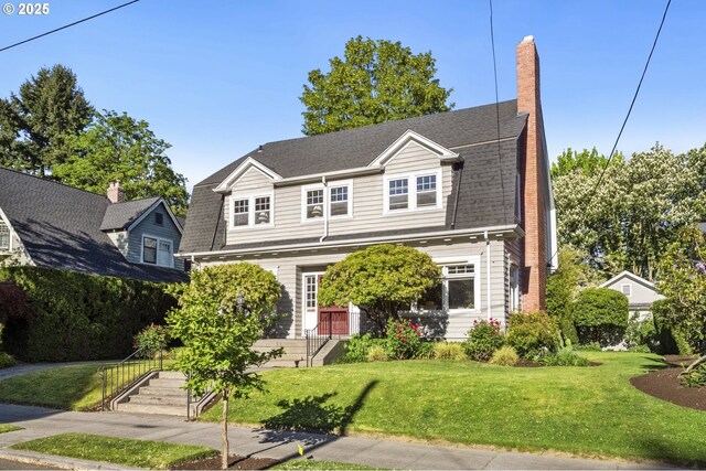 view of front of property with a chimney and a front yard