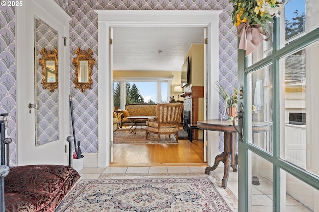 hallway with french doors and light tile patterned floors