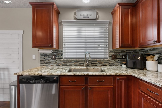 15574 Bachelor Ave, Sandy, OR 97055 - kitchen with stainless steel dishwasher, backsplash, light stone counters, reddish brown cabinets, and a textured ceiling