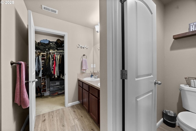 15574 Bachelor Ave, Sandy, OR 97055 - bathroom featuring vanity, wood finished floors, and a spacious closet