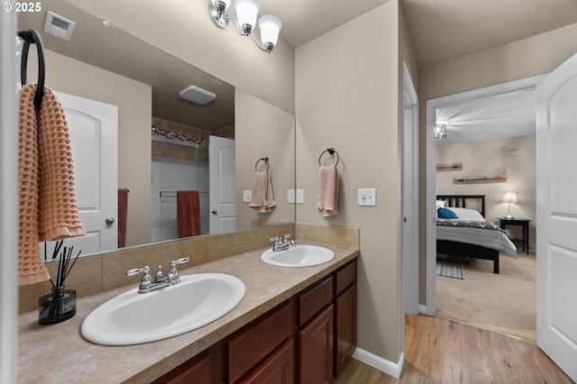 15574 Bachelor Ave, Sandy, OR 97055 - bathroom with double vanity, wood finished floors, connected bathroom, and a shower