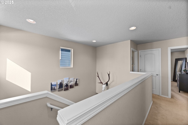 15574 Bachelor Ave, Sandy, OR 97055 - hallway featuring light carpet, an upstairs landing, recessed lighting, and a textured ceiling
