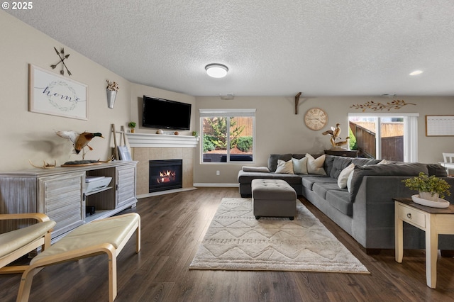 15574 Bachelor Ave, Sandy, OR 97055 - living room with a textured ceiling, a tiled fireplace, and dark wood finished floors