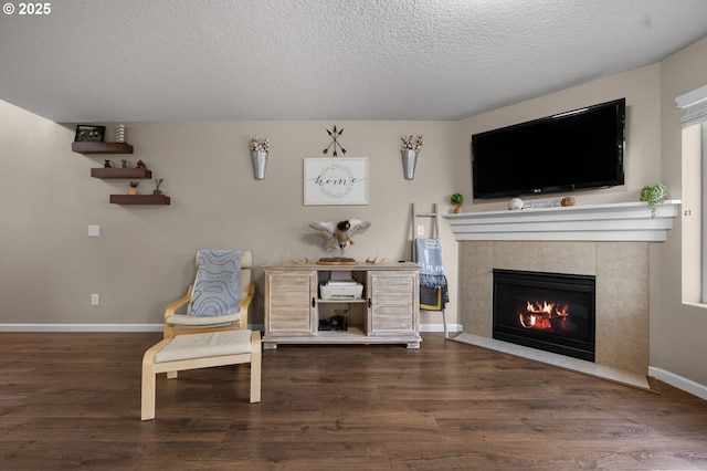 15574 Bachelor Ave, Sandy, OR 97055 - living area with a tile fireplace, a textured ceiling, and wood finished floors
