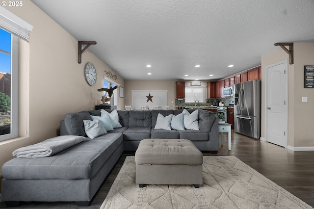 15574 Bachelor Ave, Sandy, OR 97055 - living room featuring recessed lighting, dark wood finished floors, healthy amount of natural light, and a textured ceiling