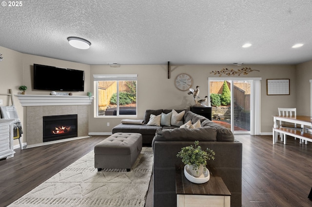 15574 Bachelor Ave, Sandy, OR 97055 - living area featuring a textured ceiling, wood finished floors, a tiled fireplace, and recessed lighting