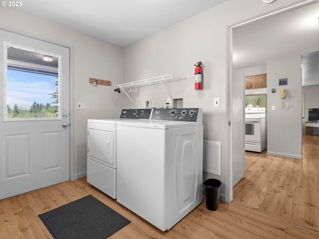 6229 NW Skyline Blvd, Portland, OR 97229 - laundry area with washer and dryer, laundry area, light wood-style floors, and visible vents