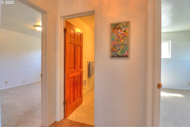 hall with carpet and baseboards