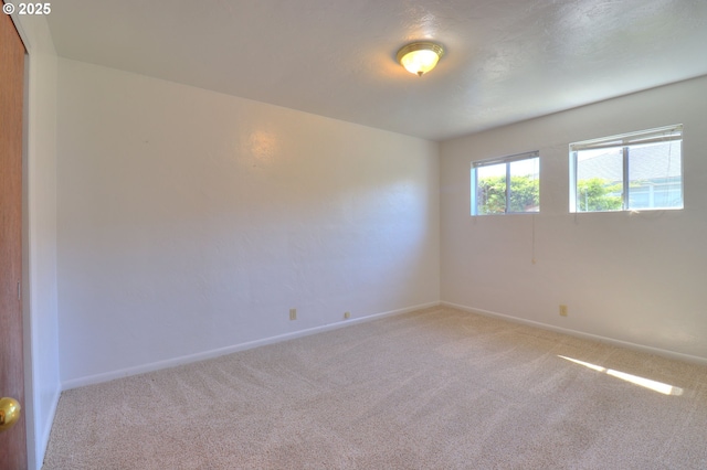 empty room with carpet flooring and baseboards