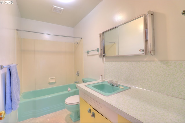 bathroom featuring toilet, vanity, tile patterned floors, and shower / washtub combination