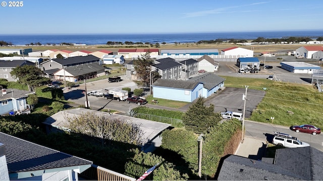 aerial view of residential area featuring a nearby body of water