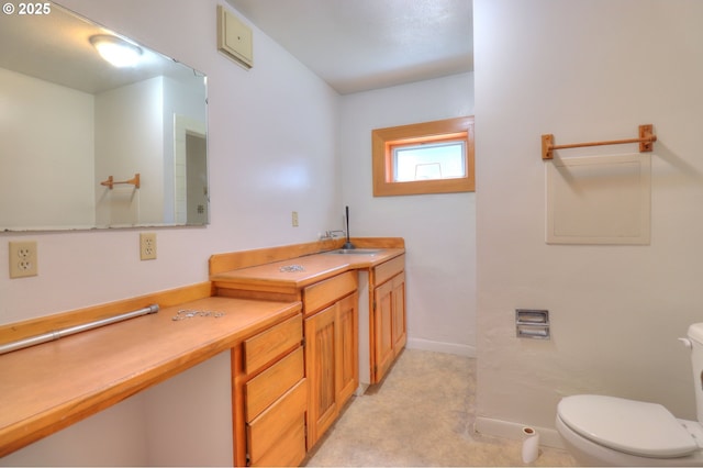 bathroom with toilet and vanity