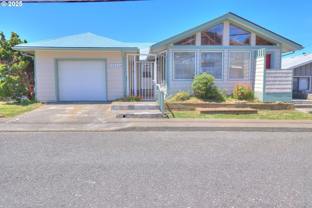 single story home featuring driveway and a garage