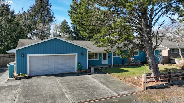 ranch-style house with a garage, driveway, fence, and a front yard