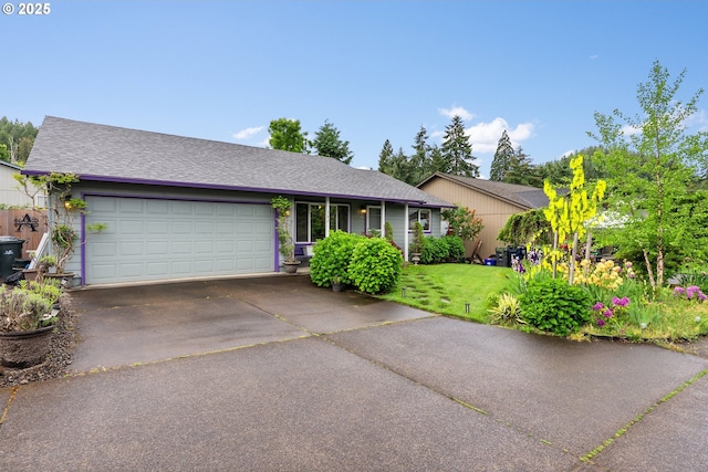 ranch-style house with a garage, driveway, a front yard, and a shingled roof