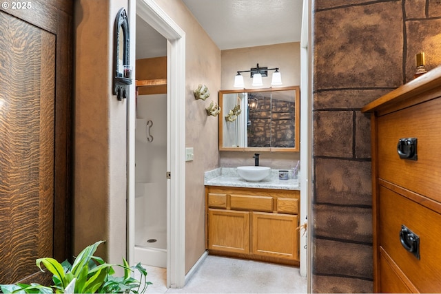 full bathroom featuring a stall shower and vanity