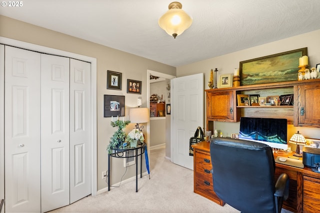 office area featuring light colored carpet and baseboards