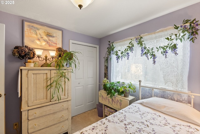 bedroom with light carpet and a closet