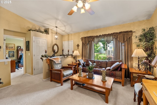 carpeted living room featuring ceiling fan and lofted ceiling