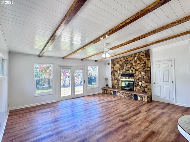 337 Spruce Dr, Brookings, OR 97415 - unfurnished living room with beamed ceiling, wood finished floors, a fireplace, baseboards, and a ceiling fan
