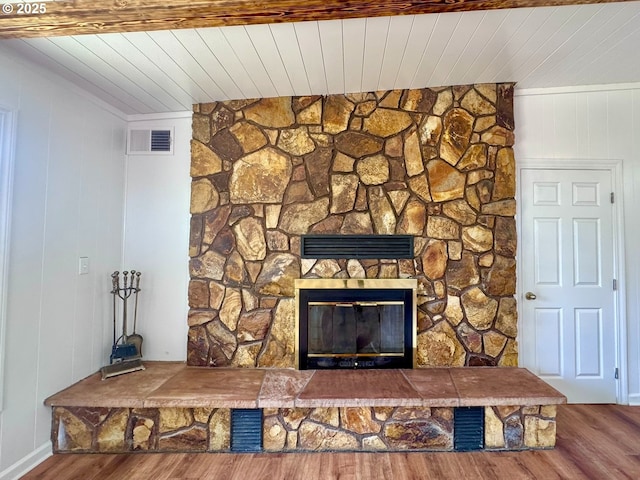 337 Spruce Dr, Brookings, OR 97415 - detailed view of wood finished floors, a stone fireplace, and wood ceiling