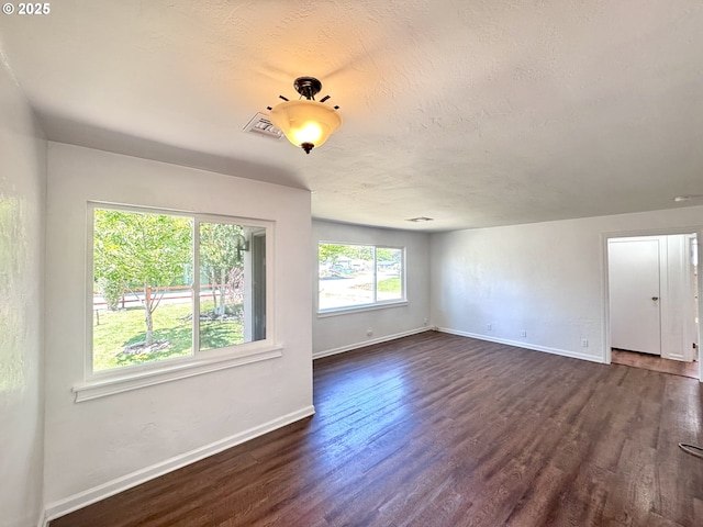 337 Spruce Dr, Brookings, OR 97415 - empty room featuring baseboards, dark wood-style floors, and a textured ceiling
