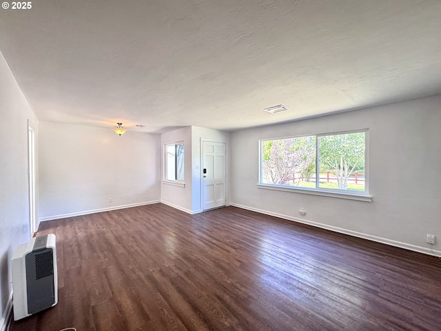 337 Spruce Dr, Brookings, OR 97415 - unfurnished room with dark wood finished floors, healthy amount of natural light, and baseboards