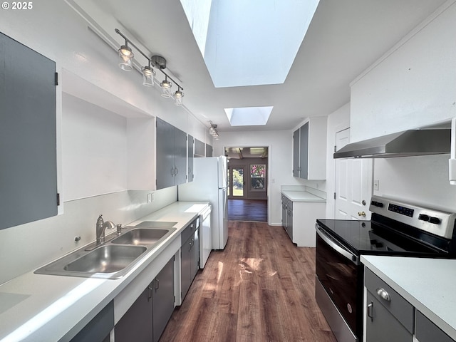 337 Spruce Dr, Brookings, OR 97415 - kitchen featuring electric range, a sink, exhaust hood, a skylight, and dark wood-type flooring