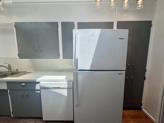 337 Spruce Dr, Brookings, OR 97415 - kitchen with freestanding refrigerator, dishwasher, a sink, light countertops, and gray cabinets