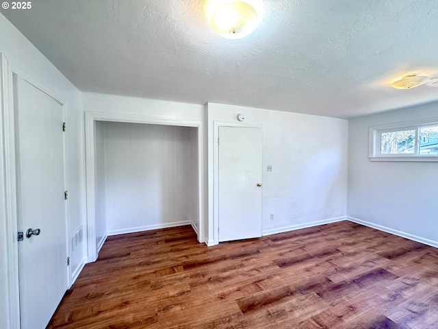 337 Spruce Dr, Brookings, OR 97415 - additional living space featuring wood finished floors, a textured ceiling, and baseboards