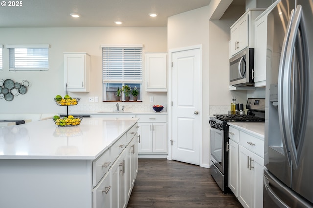 kitchen with recessed lighting, appliances with stainless steel finishes, white cabinetry, and light countertops