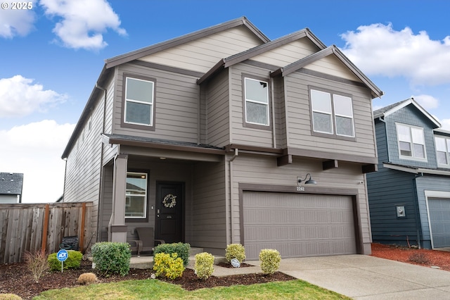 view of front of house with concrete driveway, an attached garage, and fence