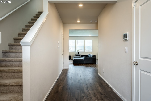 hall featuring stairway, baseboards, and dark wood-style flooring