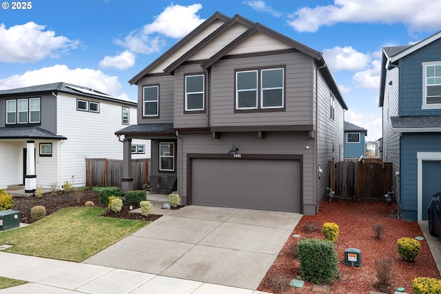 view of front facade with a front lawn, fence, a garage, and driveway