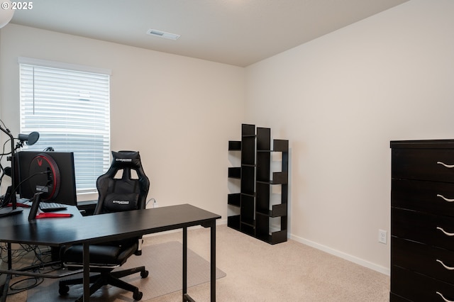 home office featuring light carpet, visible vents, and baseboards