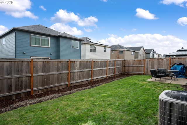 view of yard with central AC unit, a patio area, a residential view, and a fenced backyard