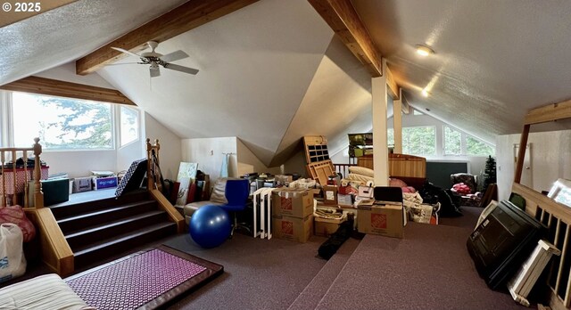 additional living space featuring lofted ceiling with beams, a textured ceiling, a ceiling fan, and carpet flooring