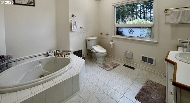 bathroom featuring toilet, a whirlpool tub, vanity, and visible vents