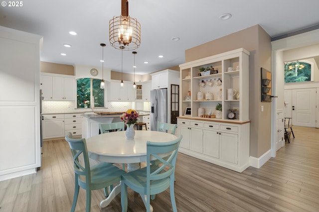 11712 Finnegans Way, Oregon City, OR 97045 - dining space featuring light wood-style floors, a chandelier, and recessed lighting