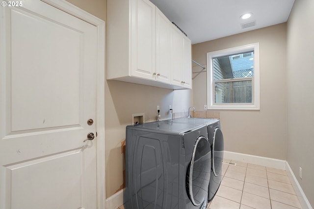 11712 Finnegans Way, Oregon City, OR 97045 - laundry area featuring washer and clothes dryer, cabinet space, light tile patterned floors, and recessed lighting