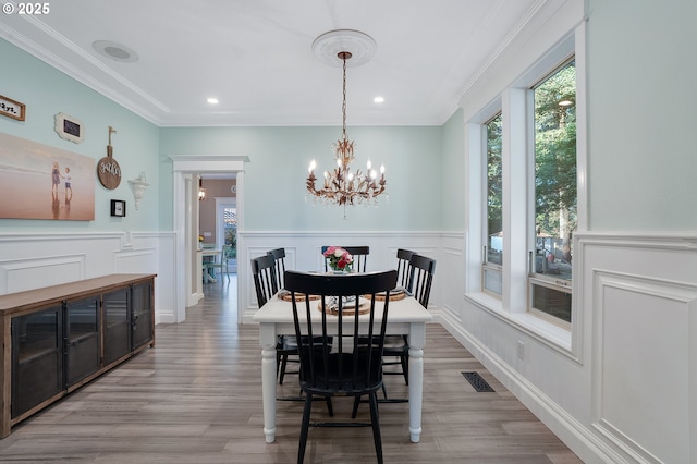 11712 Finnegans Way, Oregon City, OR 97045 - dining space with a chandelier, wood finished floors, wainscoting, crown molding, and recessed lighting