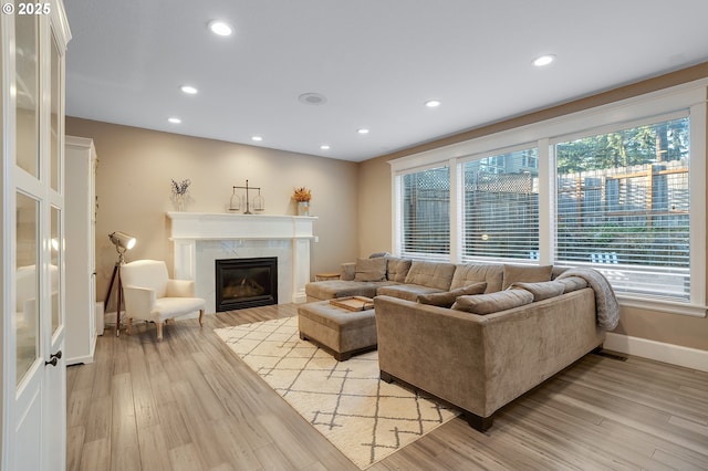 11712 Finnegans Way, Oregon City, OR 97045 - living room with light wood finished floors, a premium fireplace, and recessed lighting