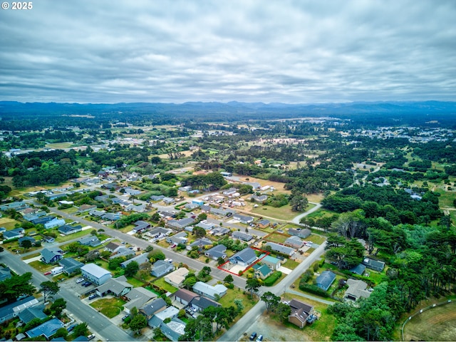 875 12th St SW, Bandon, OR 97411 - aerial view of property and surrounding area featuring property parcel outlined, a mountain backdrop, and nearby suburban area
