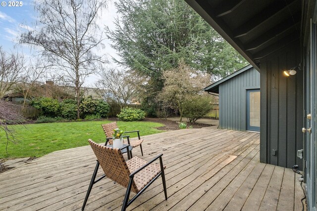 wooden deck with fence and a lawn