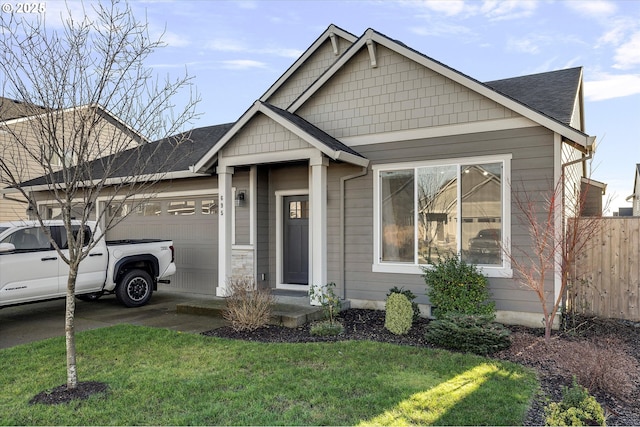 view of front facade featuring a garage and a front lawn