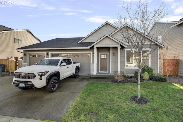 view of front of home with a garage and a front yard