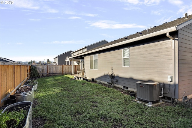 exterior space with central air condition unit and a yard