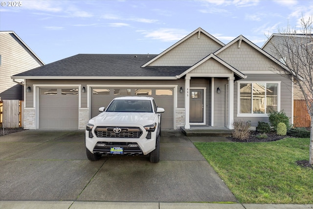 view of front facade featuring a garage and a front lawn