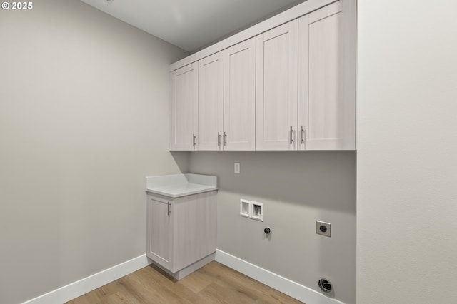 laundry area featuring cabinets, hookup for a gas dryer, washer hookup, light hardwood / wood-style floors, and electric dryer hookup