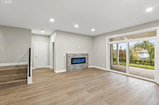 unfurnished living room featuring a fireplace and light hardwood / wood-style flooring